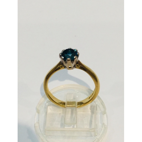 187 - An 18ct yellow gold solitaire blue diamond ring, the round diamond is set in eight platinum claws, e... 