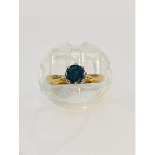 187 - An 18ct yellow gold solitaire blue diamond ring, the round diamond is set in eight platinum claws, e... 