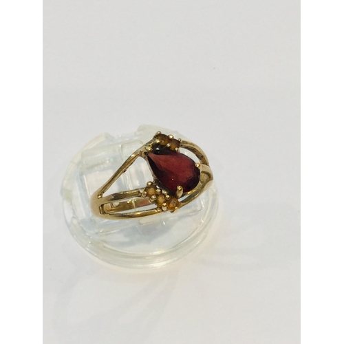 189 - A 9ct yellow gold dress ring, set with a large opaque ruby in a four claw setting, ring weighs 5.8 g... 