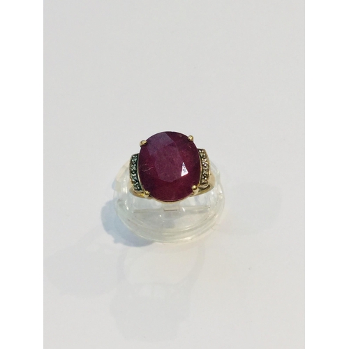 189 - A 9ct yellow gold dress ring, set with a large opaque ruby in a four claw setting, ring weighs 5.8 g... 