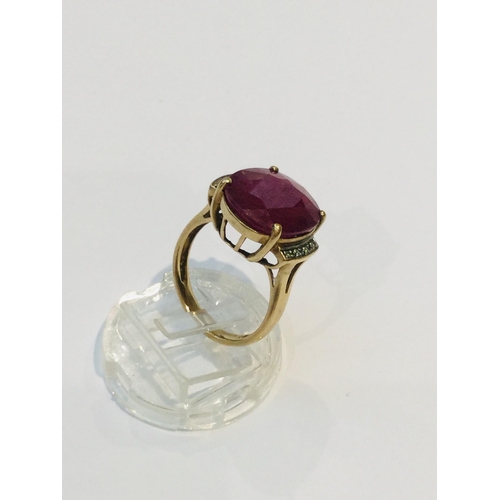 189 - A 9ct yellow gold dress ring, set with a large opaque ruby in a four claw setting, ring weighs 5.8 g... 