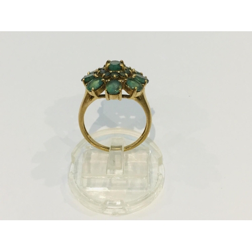 191 - A 9ct yellow gold peridot dress ring in a floral design, weighing 4.4 grams, finger size N.  Togethe... 