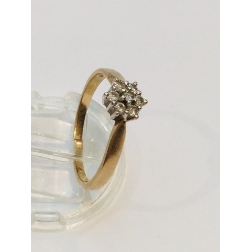 192 - A 9ct yellow gold diamond daisy ring, set with seven small round brilliant cut diamonds in a claw se... 