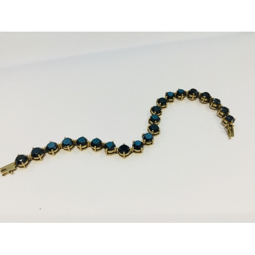 197 - A 9ct gold tennis bracelet, set with 21 x round black diamonds in a claw setting, weighs 19.0 grams.