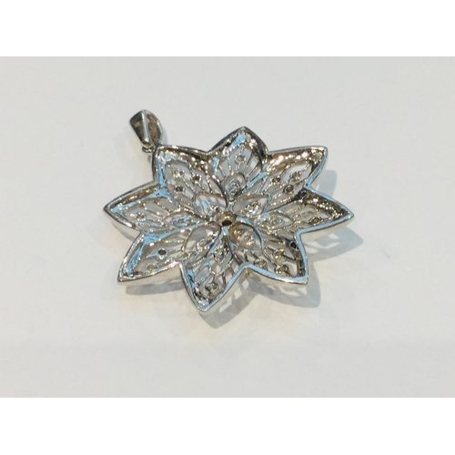 199 - A 9ct white gold floral pendant set with small round diamonds, weighs 8.3 grams.