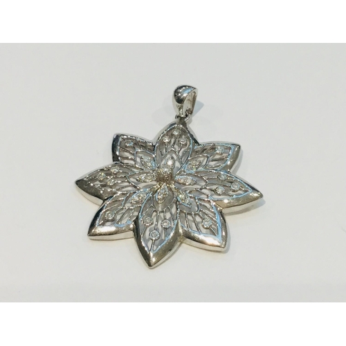 199 - A 9ct white gold floral pendant set with small round diamonds, weighs 8.3 grams.