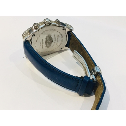 202 - An Aqua Marin wristwatch, with diamond set bezel on blue leather strap, multi dial face with deploym... 