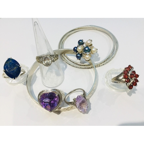 203 - A selection of silver jewellery including four slave bangles and six various stone set dress rings. ... 