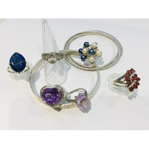 203 - A selection of silver jewellery including four slave bangles and six various stone set dress rings. ... 