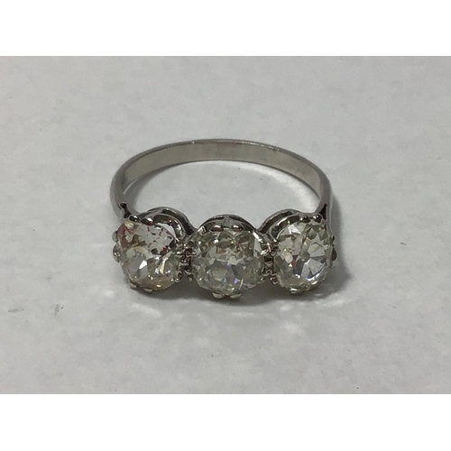 204 - A platinum three-stone diamond ring, claw set with old-cut diamonds, the diamonds weighing a total o... 