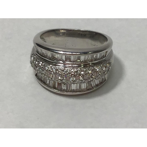 207 - An 18ct white gold three row ring, channel set with baguette diamonds to the outer rows and pave set... 