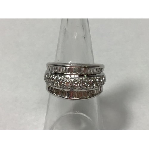 207 - An 18ct white gold three row ring, channel set with baguette diamonds to the outer rows and pave set... 