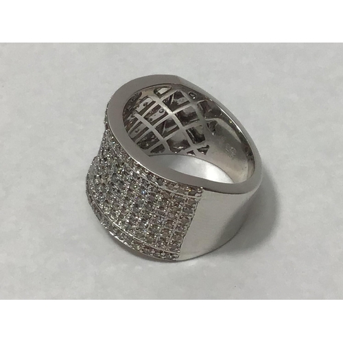 208 - An 18ct white gold wide band ring, claw set with eight rows of round brilliant-cut diamonds, the two... 