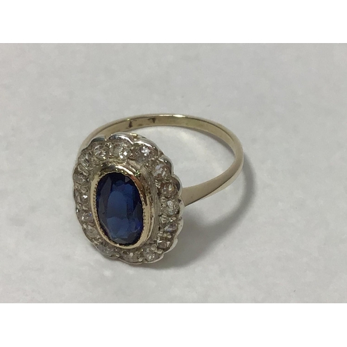 209 - A 9ct gold cluster ring, rubover set with a central oval sapphire surrounded by sixteen diamonds, th... 