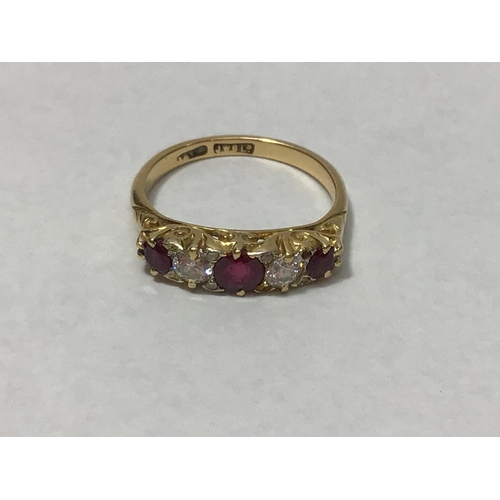 210 - An 18ct gold five stone ring, with carved mount, claw set with three graduated rubies and two diamon... 