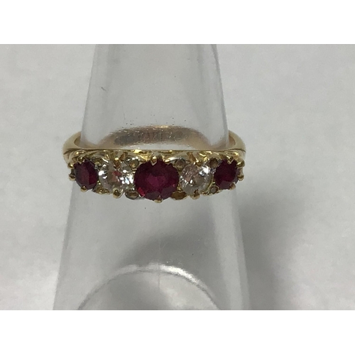 210 - An 18ct gold five stone ring, with carved mount, claw set with three graduated rubies and two diamon... 