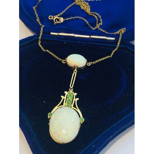 216 - An early 20th century 15ct gold double oval opal and green stone drop pendant on fixed chain, the op... 