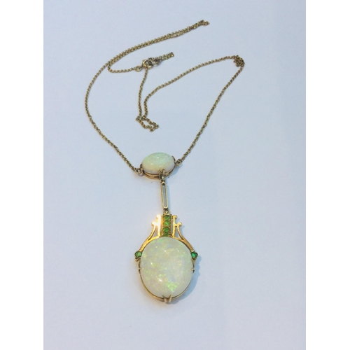 216 - An early 20th century 15ct gold double oval opal and green stone drop pendant on fixed chain, the op... 