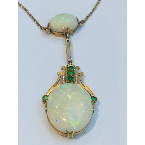 216 - An early 20th century 15ct gold double oval opal and green stone drop pendant on fixed chain, the op... 