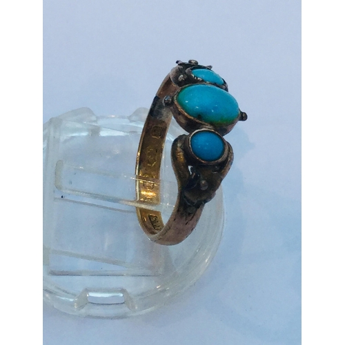 218 - An 18ct gold turquoise dress ring, set with three oval turquoise stones in a rub over setting, weigh... 