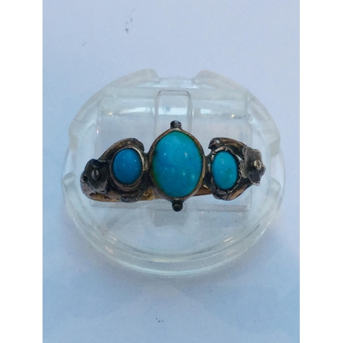 218 - An 18ct gold turquoise dress ring, set with three oval turquoise stones in a rub over setting, weigh... 