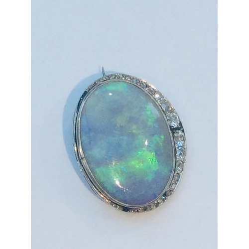 219 - A large green opal and diamond oval brooch, the opal measuring approximately 28x21mm, estimated opal... 