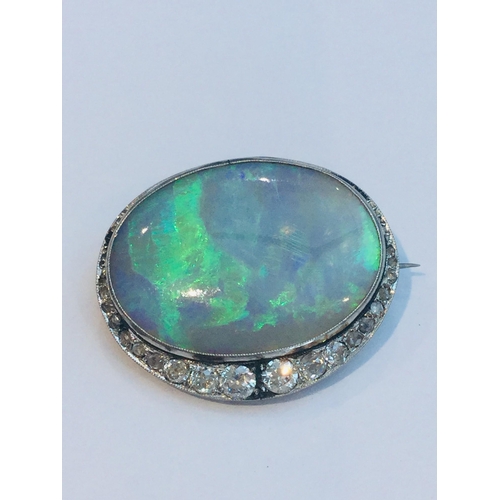 219 - A large green opal and diamond oval brooch, the opal measuring approximately 28x21mm, estimated opal... 