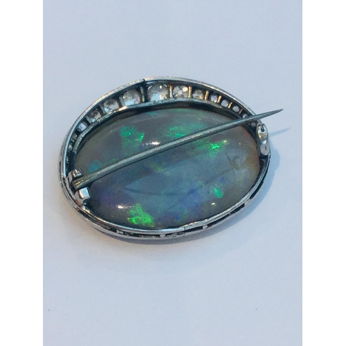 219 - A large green opal and diamond oval brooch, the opal measuring approximately 28x21mm, estimated opal... 