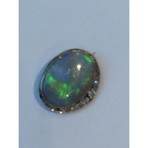 219 - A large green opal and diamond oval brooch, the opal measuring approximately 28x21mm, estimated opal... 