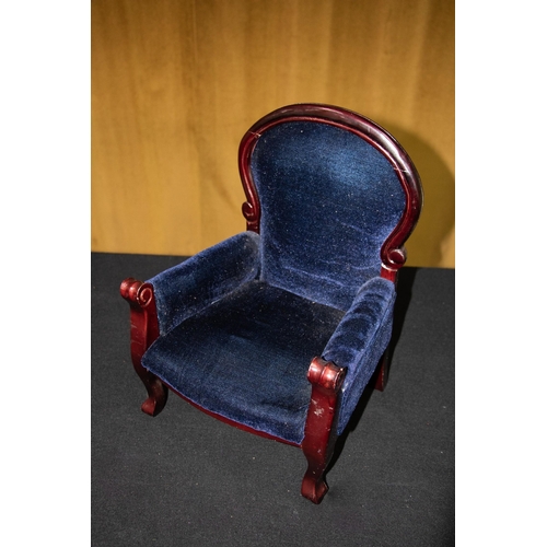 78A - A small stained mahogany doll's armchair, with padded deep blue velvet upholstery, 42cm tall