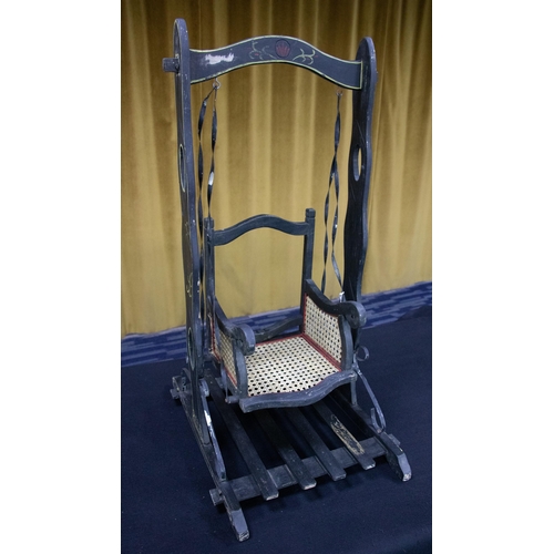 148A - A Victorian fairground 'style' doll's swing chair, the wooden frame painted black with lined detail,... 