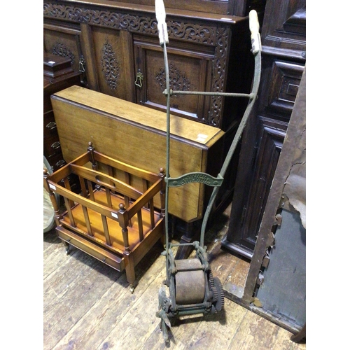 180A - An early 20th century lawn edge trimmer with twin wooden handles, central plate reading 'Ransomes Ed... 