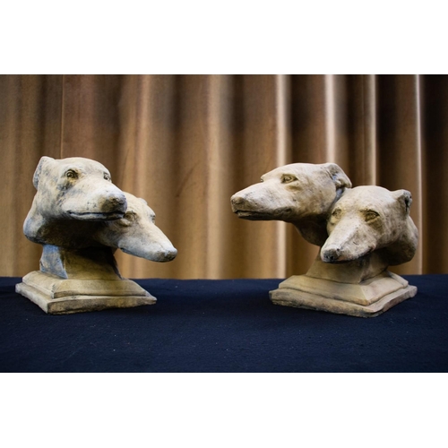 214A - A pair of reconstituted stone sculptures, each modelled as two racing greyhound heads, raised on ste... 