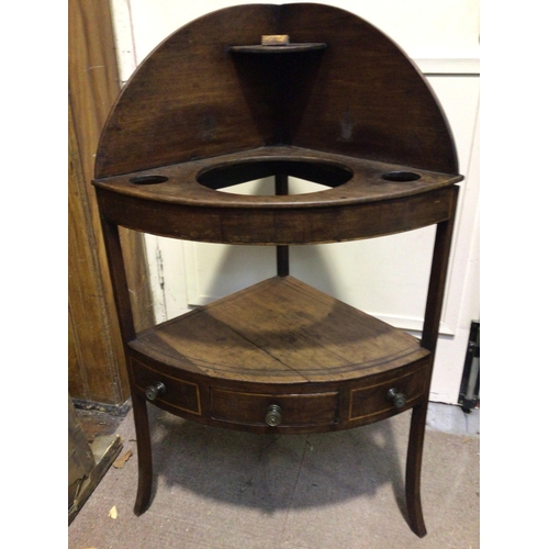 309A - A Georgian mahogany corner wash stand with circular receptacles for basin and brush pots, the lower ... 