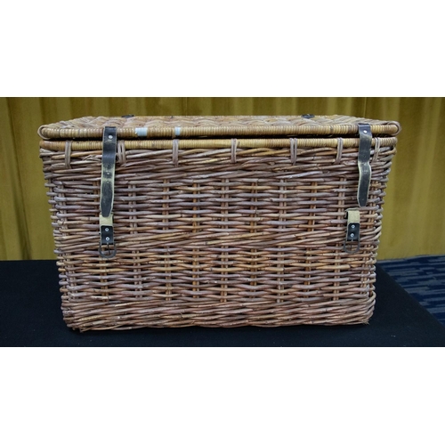 325C - An oversized wicker basket/hamper of rectangular form, with leather strap locks and handle to either... 