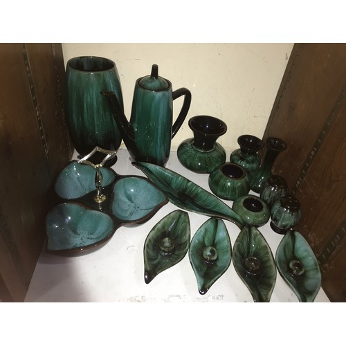 31 - SECTION 31 & 32.  Two shelves of Canadian Blue Mountain reflowing glazed pottery items including a s... 