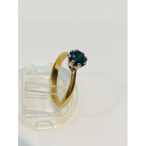 191 - An 18ct yellow gold solitaire blue diamond ring, the round diamond is set in eight platinum claws, e... 