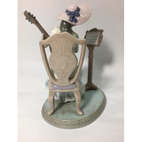 41 - A Lladro porcelain figure of a seated lady playing guitar with music stand, ‘Sweet Song No. 06408’, ... 