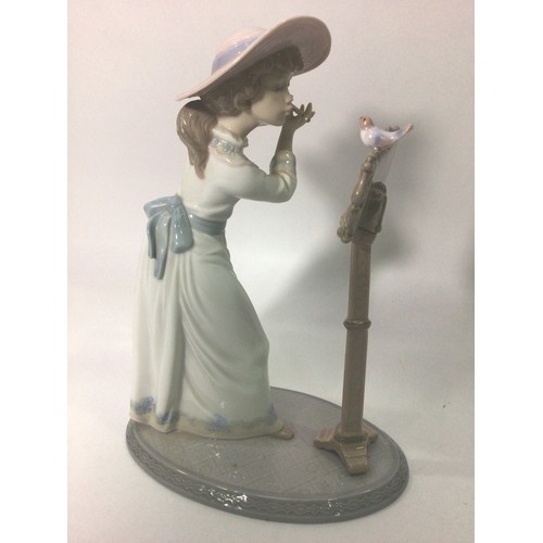 45 - A Lladro porcelain figure of a lady playing the flute, ‘Songbird No. 6093’, signed to base, 24cm hig... 