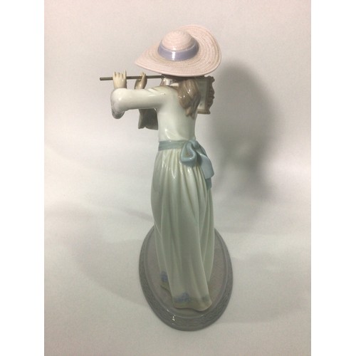 45 - A Lladro porcelain figure of a lady playing the flute, ‘Songbird No. 6093’, signed to base, 24cm hig... 