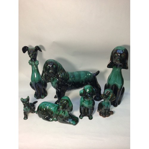 83 - Seven various Canadian Blue Mountain reflowing glazed pottery figures of dogs, the tallest 36cm high... 