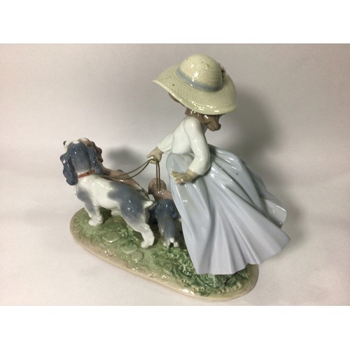 114 - A Lladro porcelain figure group of a young girl walking two spaniels with five puppies in tow, ‘Pupp... 