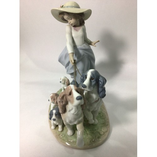 114 - A Lladro porcelain figure group of a young girl walking two spaniels with five puppies in tow, ‘Pupp... 