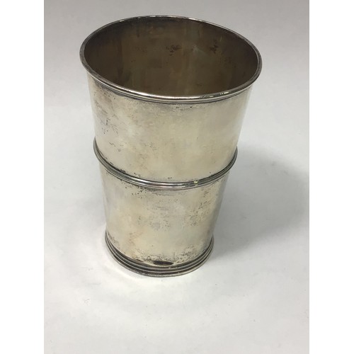 140 - An Edwardian silver and silver-gilt beaker of tapering cylindrical form, with three horizontal bands... 