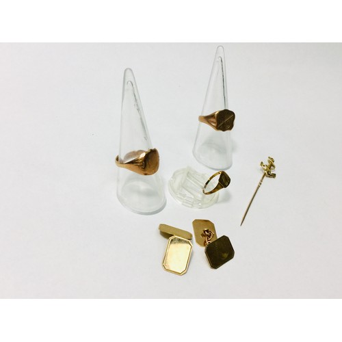 233 - A selection of 9ct gold jewellery including three signet rings, a pair of cufflinks and an anchor ti... 