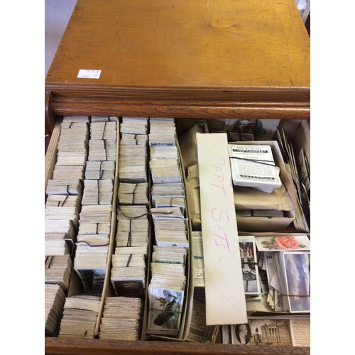 239 - An extensive collection of vintage cigarette cards, loose in bundles and within a three drawer table... 