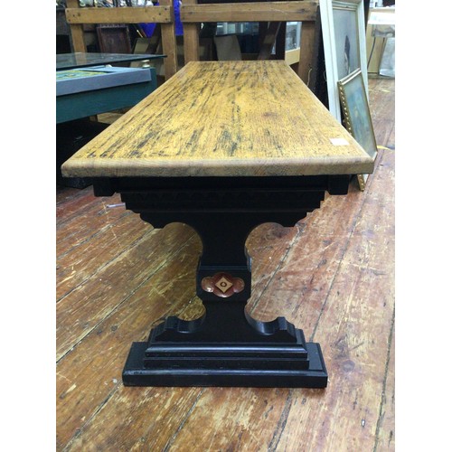 421 - An oak bench / seat with black painted legs and stretcher with carved detail and red and gilt painte... 