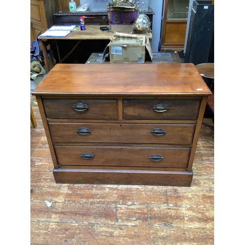 418 - An Edwardian walnut chest of two short and two long graduated drawers with oval brass handles, on pl... 