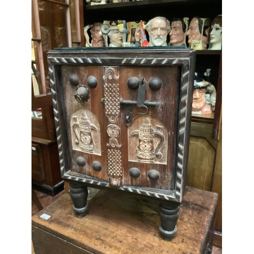 423 - Ethnic free standing carved corner cabinet with detailed carving, iron bolt lock, roped edging and g... 