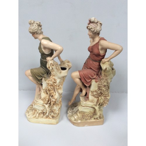 36 - Two matching Royal Dux porcelain figural spill vases modelled as classical maidens, each sat atop a ... 